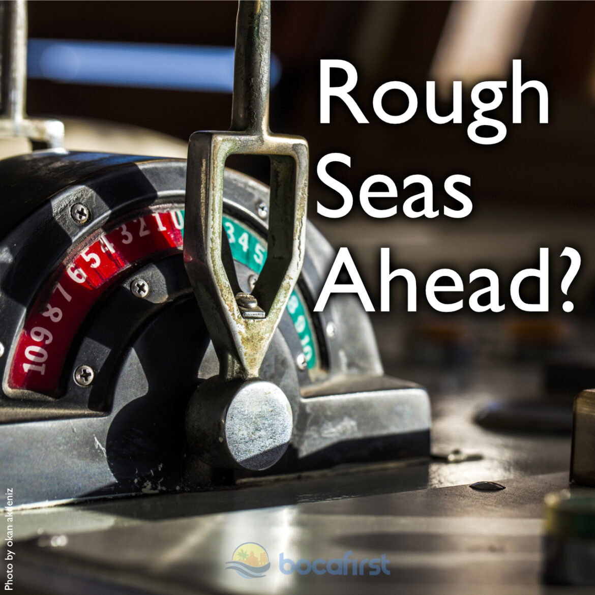 A ship's engine order telegraph with red and green order dials in warm sunlight, headlined Rough Seas Ahead?